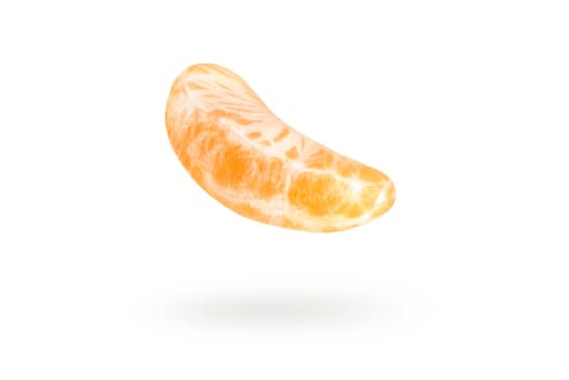 A piece of mandarin isolated on a white background, falling casting a shadow. Individual segments of tangerine slices, for inserting into a project or design