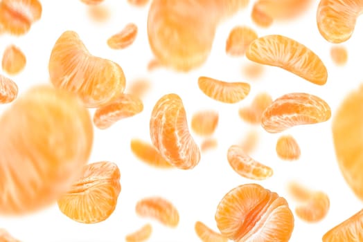Falling mandarin slices on a white isolated background. Citrus fruit background, yellow tangerine slices with selective focus.