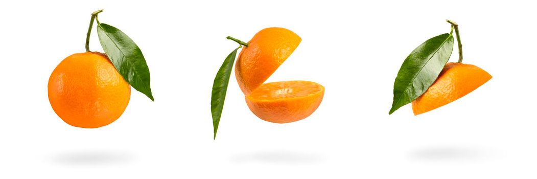 Set mandarin cut in half with a green leaf. Fresh tangerine on a white isolated background. Open mouth concept. Tangerine texture close up