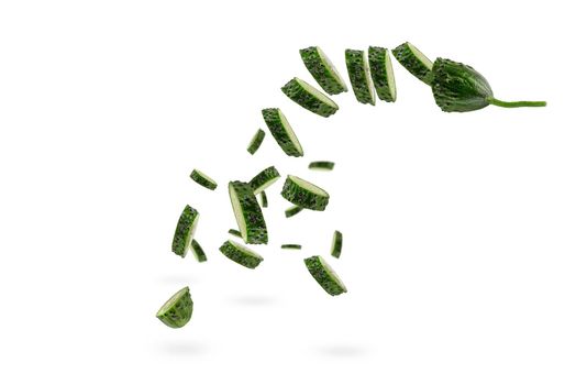 Falling cucumber slices on white isolated background. The cucumber scatters. Cut fresh cucumber into slices hanging in the air