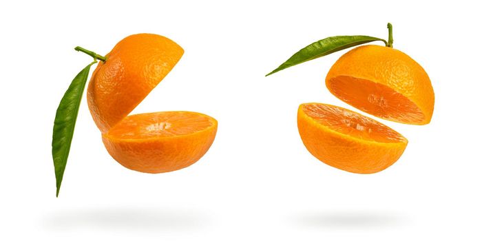 Set mandarin cut in half with a green leaf. Fresh tangerine on a white isolated background. Open mouth concept. Tangerine texture close up