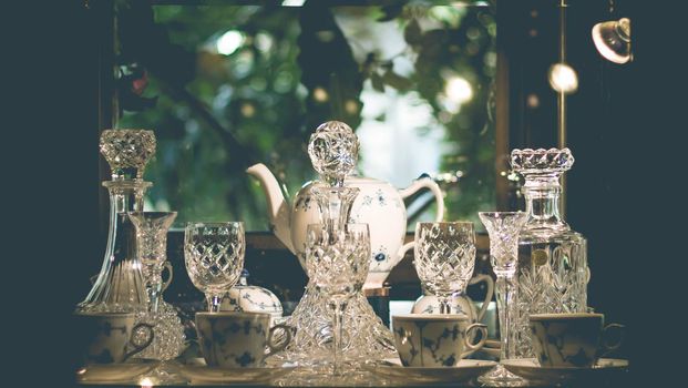 Set of Vintage crystal glasses on the black tray with Christmas decorations. Selective focus