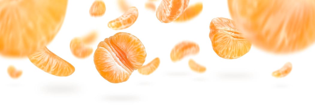 A large set of mandarin slices isolated on a white background falling down casting a shadow. Separate tangerine slices to insert into a project or design.