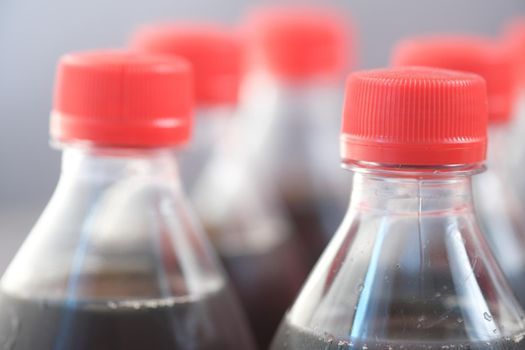 plastic bottles of soft drink on table .