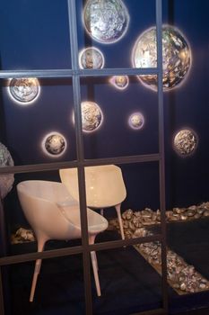 interior view of white creative chairs near wall with shiny decorative planets