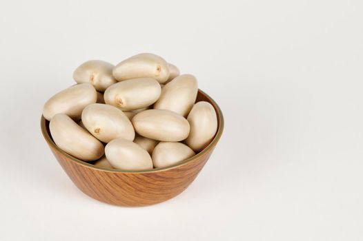 Closeup view of Bowl containing jackfruit seeds on a white background