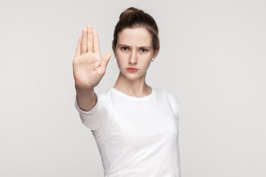 Stop sign. Focus on hand. Body language. Gray background