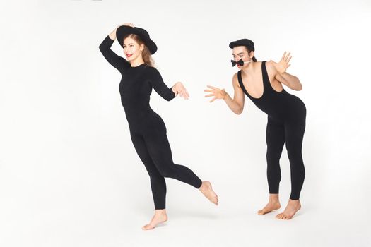 Two circus mimes clown showing sketch about love. Studio shot, isolated on white background