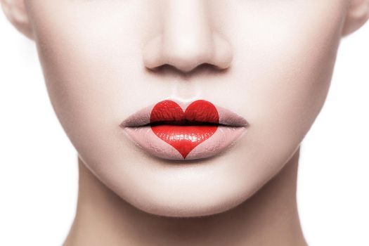 Closeup portrait of beautiful woman face with makeup and red heart shape on her lips. valentines day and beauty love and care concept. indoor studio shot, Isolated on white background.