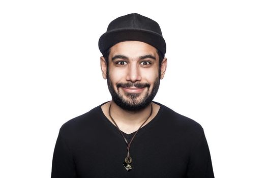Portrait of young happy smilely man with black t-shirt and cap looking at camera with smile. studio shot, isolated on white background.