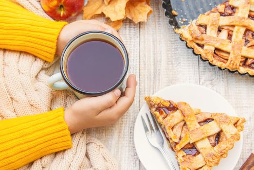 Child with a cup of tea in his hands. Selective focus. autumn.