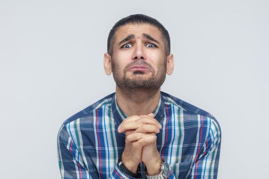 Please help me! Bearded man need a help. Isolated on gray background, studio shot