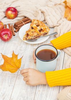 Child with a cup of tea in his hands. Selective focus. autumn.