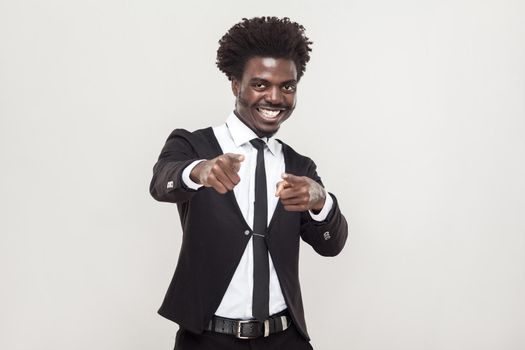 Happiness african man pointing fingers at camera. Studio shot, gray background