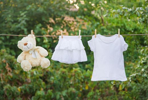 White clothes dry on a rope in the summer. Selective focus. nature.