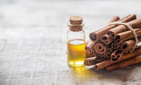 Cinnamon essential oil in a small bottle. Selective focus. nature.