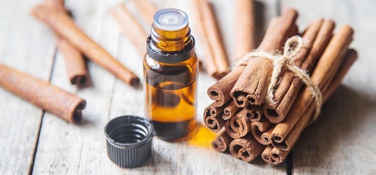 Cinnamon essential oil in a small bottle. Selective focus. nature.