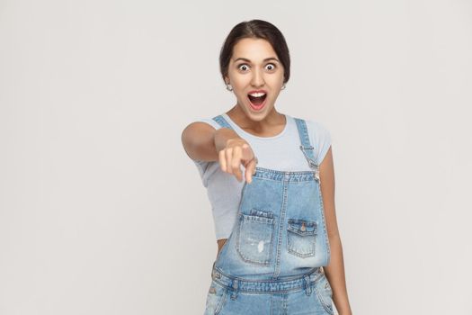 Wow that's great! Portrait of young adult caucasian woman with shocked facial expression. Indoor, studio shot