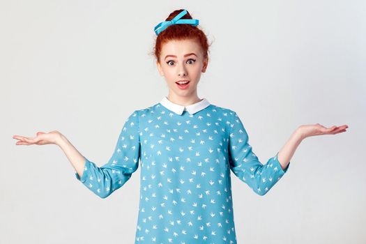 Body language. Positive emotions. Isolated studio shot on gray background of young surprised and astonished young caucasian redhead girl gesturing in full disbelief,