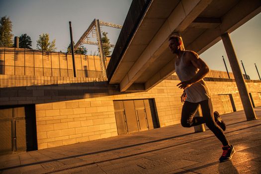 Aged sportsman running on country road, healthy inspirational fitness lifestyle, sport motivation speed interval training. Runner jogging training and doing workout exercising power walking outdoors in city.