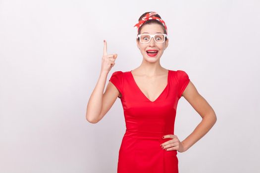 Yes! Success creative woman find idea!. Indoor, studio shot, isolated on gray background