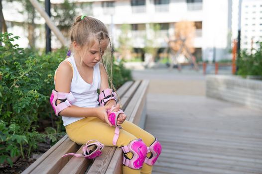 Little girl learns to roller skate outdoors