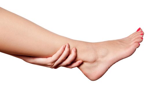 Closeup view of a young woman with pain on leg on white background.