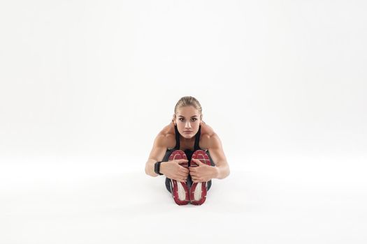 Fitness woman doing at the work-out morning, tilt forward. Studio shot