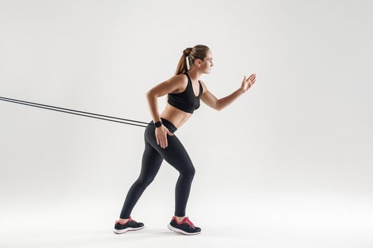 Crossfit and work-out. Activity concept, woman running. Studio shot