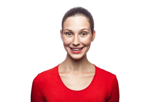 Portrait of happy smiley woman in red t-shirt with freckles. looking at camera with toothy smile, studio shot. isolated on white background. .