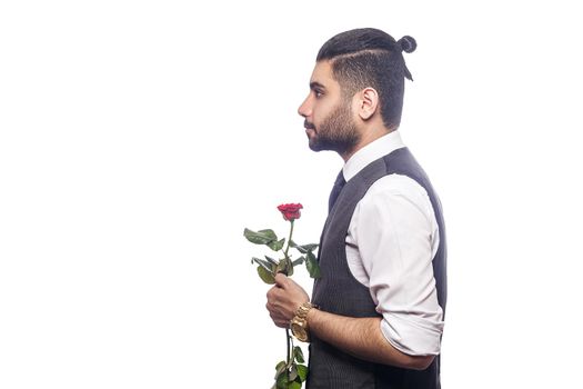 Handsome romantic happy man with rose flower. studio shot. isolated on white background..