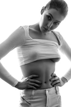 Beautiful young chinese european sexy fashion model posing in white t-shirt and undressing her white transparent shirt and looking at camera with passion. black and white photography, studio shot.