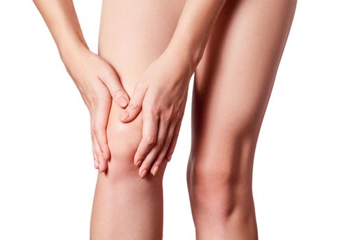 Closeup view of a young woman with knee pain on white background.