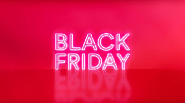 Black Friday sale. Black Friday neon sign on red studio background. Glowing white and red neon text for advertising and promotion.