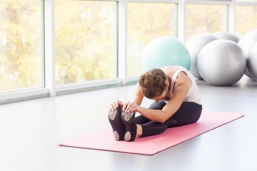 Balāsana. Seated forward bend. Child’s Pose. Woman doing tilt. Studio shot