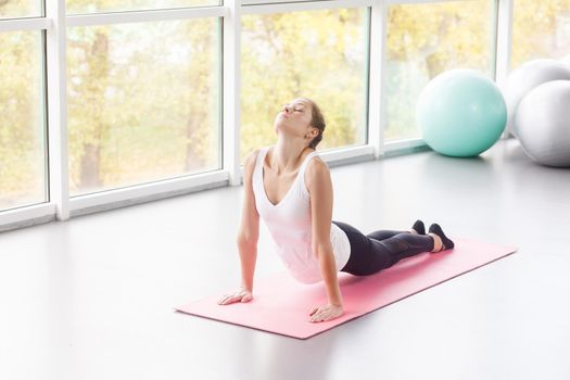 Yoga concept. Cobra pose, Bhujaṅgāsana posture. Studio shot