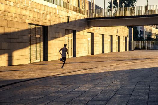 Aged sportsman running on country road, healthy inspirational fitness lifestyle, sport motivation speed interval training. Runner jogging training and doing workout exercising power walking outdoors in city.