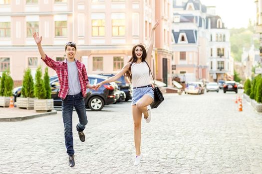 Happy smiling couple having fun in the street on summertime. .