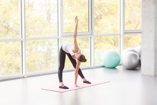 Mill, pilates exercise. Woman doing fitness. Studio shot