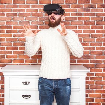 loneliness and illusion of new year. the portrait of bearded man with virtual reality glasses near new year's tree.