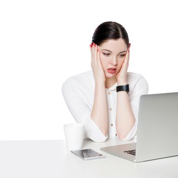 Portrait of shocked attractive brunette businesswoman in white shirt sitting looking at laptop display, reading unbelievable news and confused. indoor studio shot, isolated in white background.