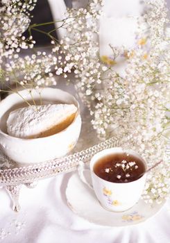 white still life with cheesecake gypsophila and cup of tea, light and airy, High quality photo,table setting for tea drinking in the English style