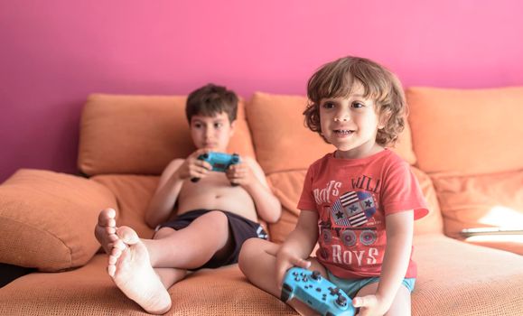 two little boys having lots of fun with video games