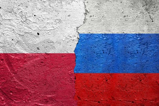 Poland and Russia flags  - Cracked concrete wall painted with a Polish flag on the left and a Rusian flag on the right