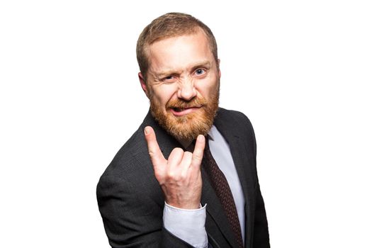 Funny businessman making horn gesture - rock and roll sign. isolated on white background, looking at camera.