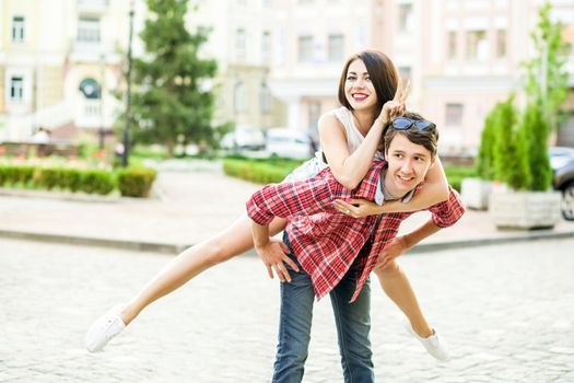 Happy smiling couple having fun in the street on summertime. .