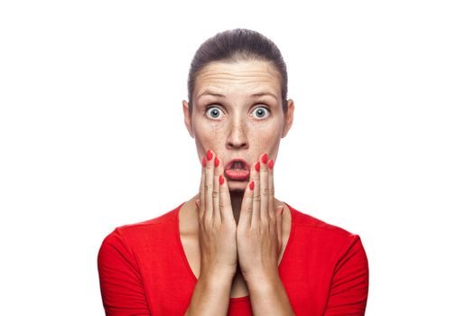 Portrait of happy surprised woman in red t-shirt with freckles. looking at camera excited with big eyes, studio shot. isolated on white background.