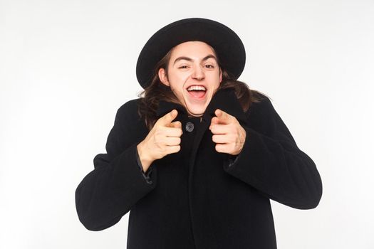 Happiness pointing finger at camera and have a shocked look. Studio shot