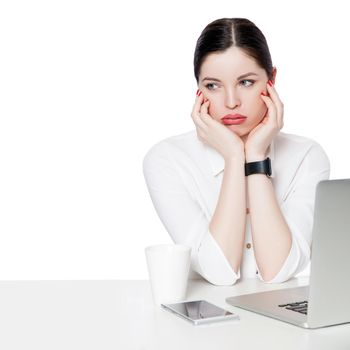 Portrait of thoughtful brunette businesswoman in white shirt sitting with laptop, touching her face, looking away, confused and thinking what to to do. indoor studio shot, isolated in white background