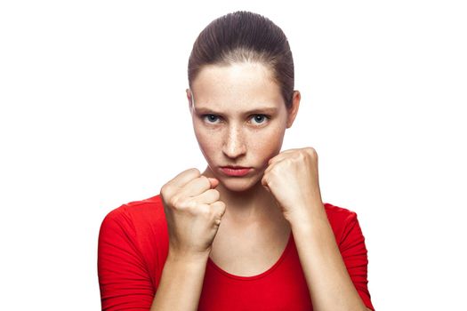 Portrait of strong boxer woman in red t-shirt with freckles with fist. looking at camera, studio shot. isolated on white background. .